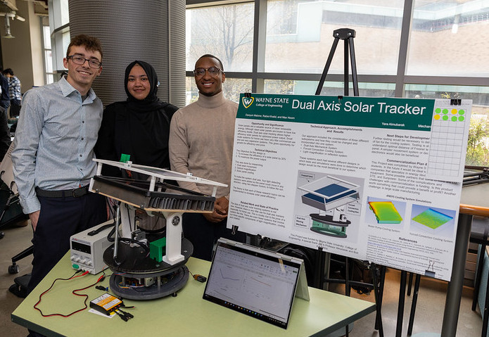 Three students pose with their Dual Axis Solar Tracker